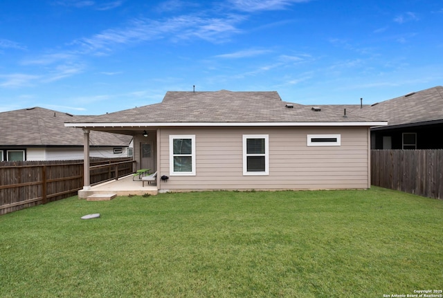 back of house with a lawn and a patio area