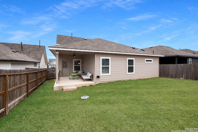 rear view of property with a yard, a patio, and ceiling fan