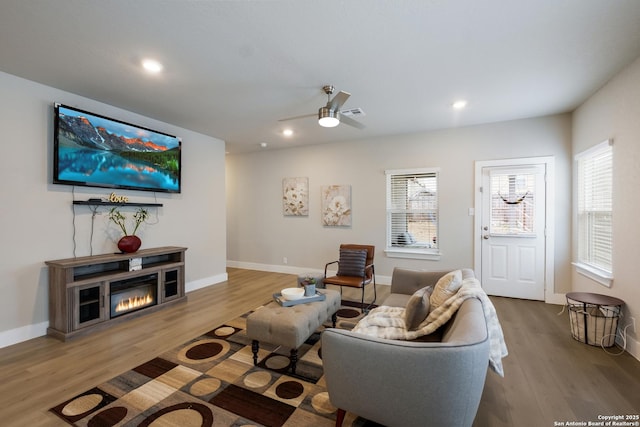 living room featuring hardwood / wood-style floors, a wealth of natural light, and ceiling fan