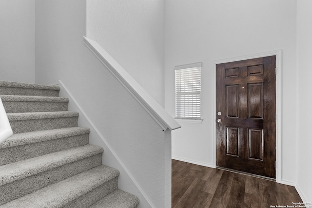 entryway with dark hardwood / wood-style flooring