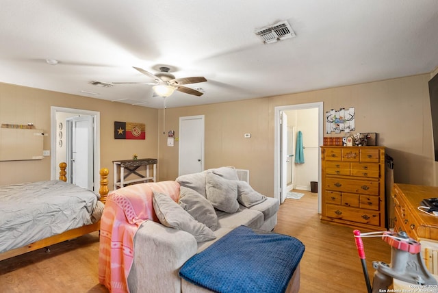 bedroom with light hardwood / wood-style flooring, ceiling fan, and ensuite bathroom