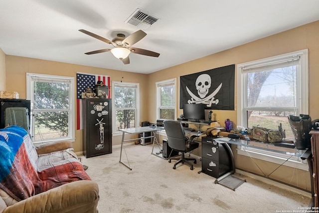 carpeted office with a healthy amount of sunlight and ceiling fan