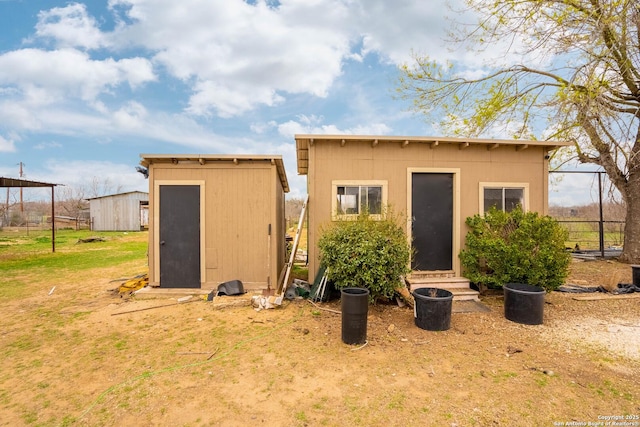 back of property featuring a shed