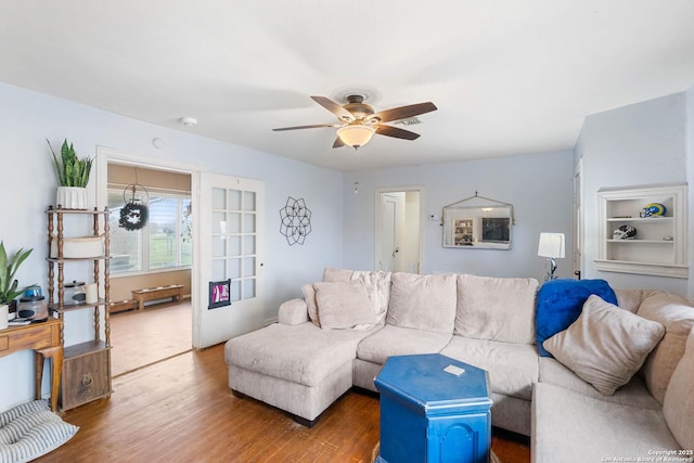 living room featuring hardwood / wood-style flooring and ceiling fan