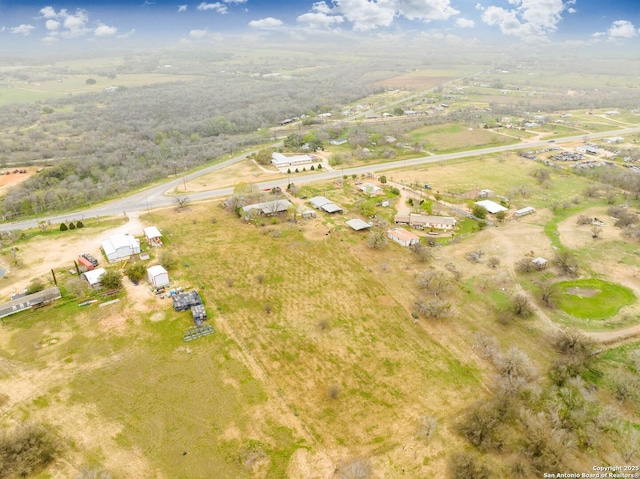 birds eye view of property with a rural view