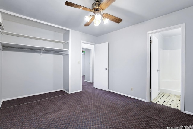 unfurnished bedroom featuring dark colored carpet, ceiling fan, and a closet