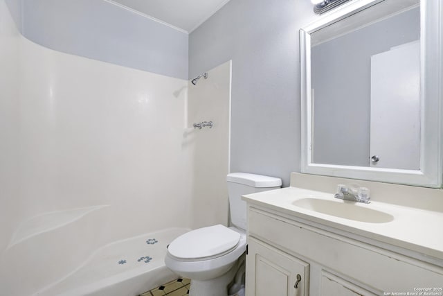 bathroom featuring vanity, toilet, and walk in shower