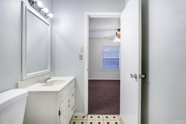 bathroom featuring ceiling fan, vanity, and toilet