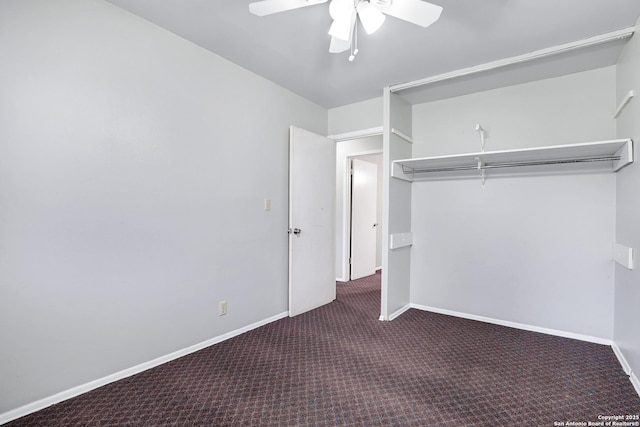 unfurnished bedroom featuring dark carpet, a closet, and ceiling fan