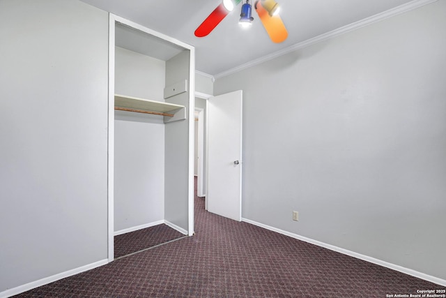 unfurnished bedroom featuring crown molding, a closet, ceiling fan, and dark colored carpet