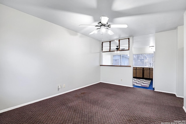 carpeted empty room featuring ceiling fan