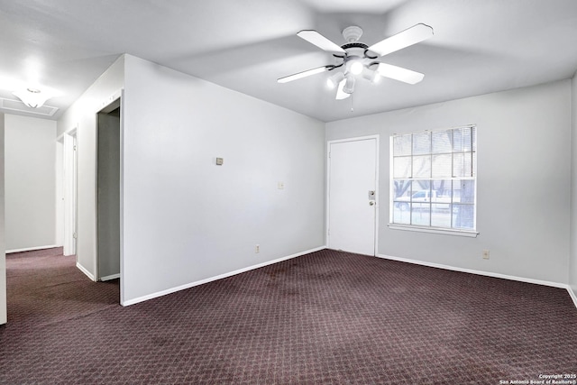 empty room featuring ceiling fan and dark carpet