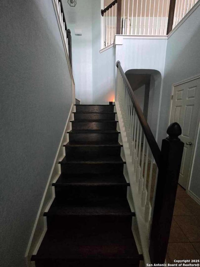 stairway with tile patterned floors