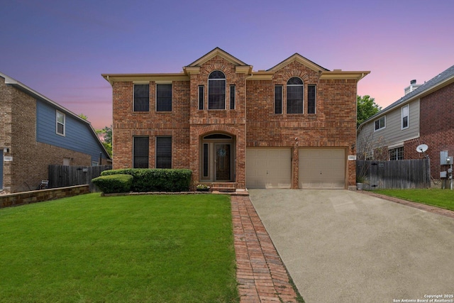 view of front of home with a yard and a garage