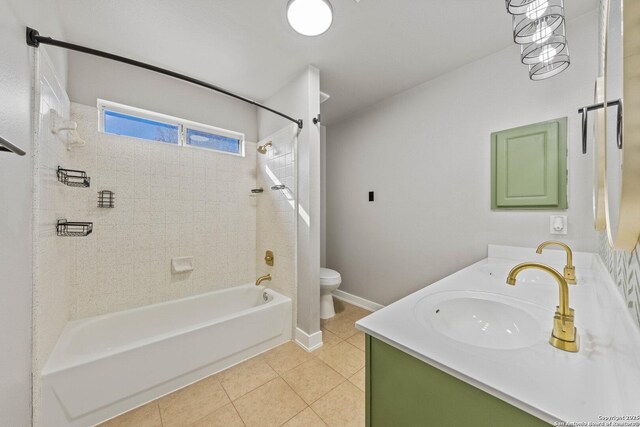 full bathroom featuring tiled shower / bath, vanity, toilet, and tile patterned floors