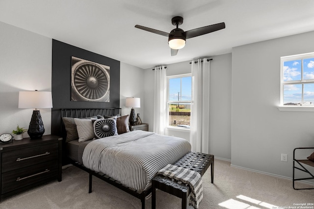 carpeted bedroom with multiple windows and ceiling fan