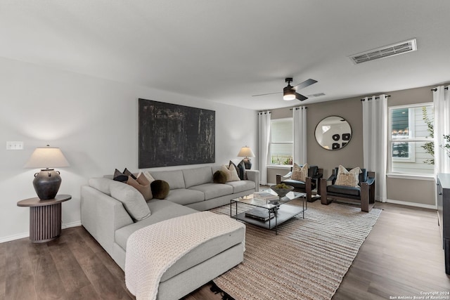 living room with dark hardwood / wood-style floors and ceiling fan