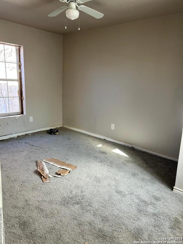 empty room with ceiling fan and carpet