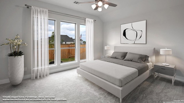 carpeted bedroom with baseboards, a ceiling fan, and vaulted ceiling
