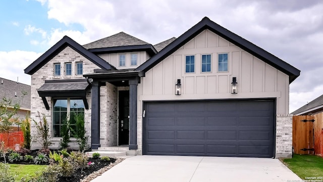 view of front of home featuring fence, board and batten siding, and driveway