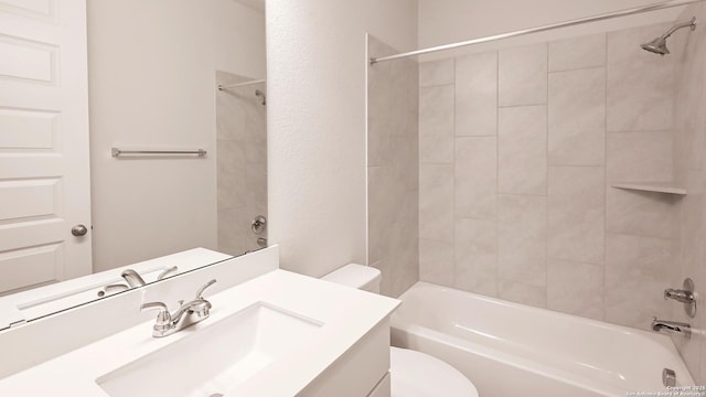 bathroom featuring vanity, shower / bathing tub combination, and toilet