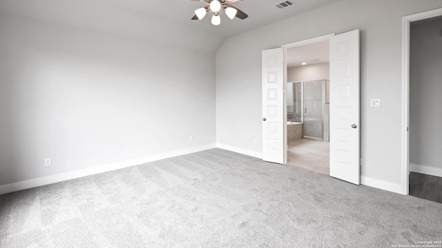 unfurnished bedroom featuring carpet flooring, ensuite bath, a ceiling fan, baseboards, and visible vents