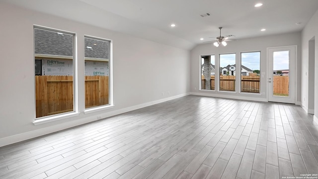 interior space with ceiling fan, visible vents, baseboards, and wood finished floors