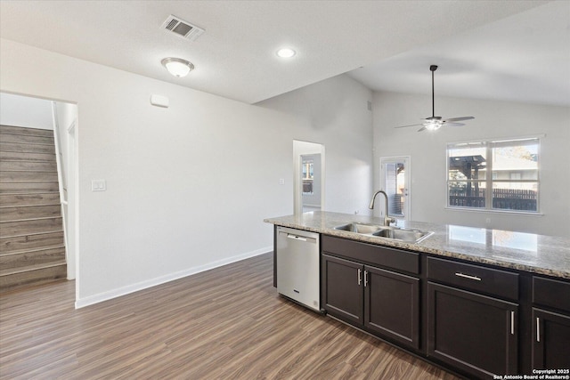 kitchen featuring sink, dark wood-type flooring, dishwasher, light stone counters, and vaulted ceiling