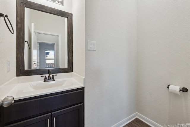 bathroom with vanity and hardwood / wood-style flooring