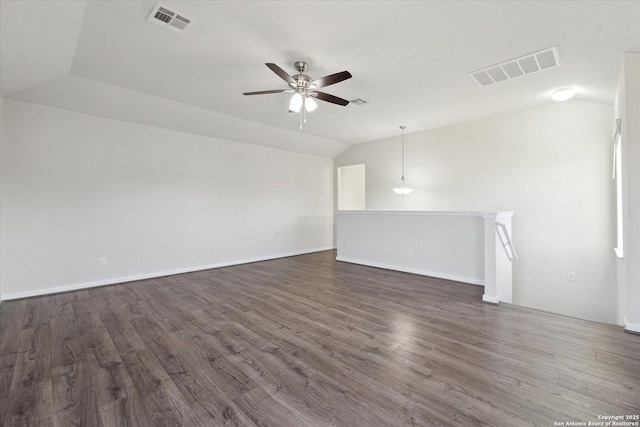 empty room featuring ceiling fan, dark hardwood / wood-style flooring, and vaulted ceiling