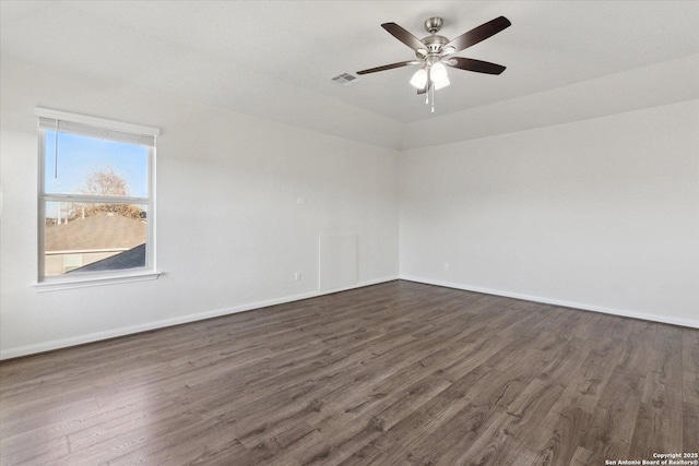 spare room featuring lofted ceiling, dark hardwood / wood-style floors, and ceiling fan