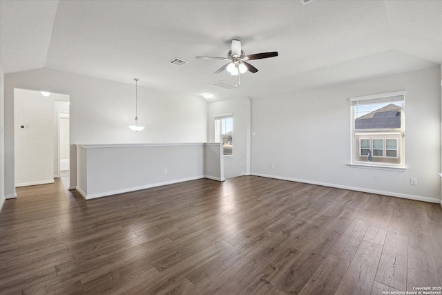 empty room featuring lofted ceiling, dark hardwood / wood-style floors, and ceiling fan