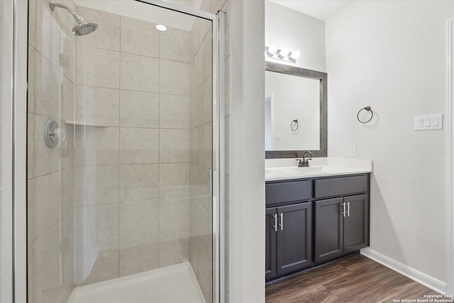 bathroom featuring a shower with door, wood-type flooring, and vanity