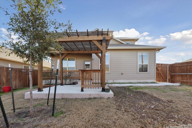 back of property featuring a pergola and a patio