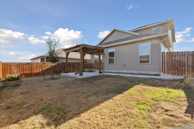 back of house featuring a patio, a yard, and a pergola