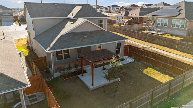 rear view of house featuring a pergola