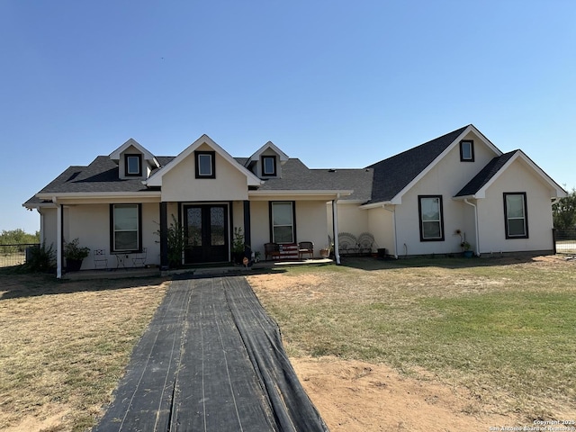 view of front of property with a front lawn and french doors