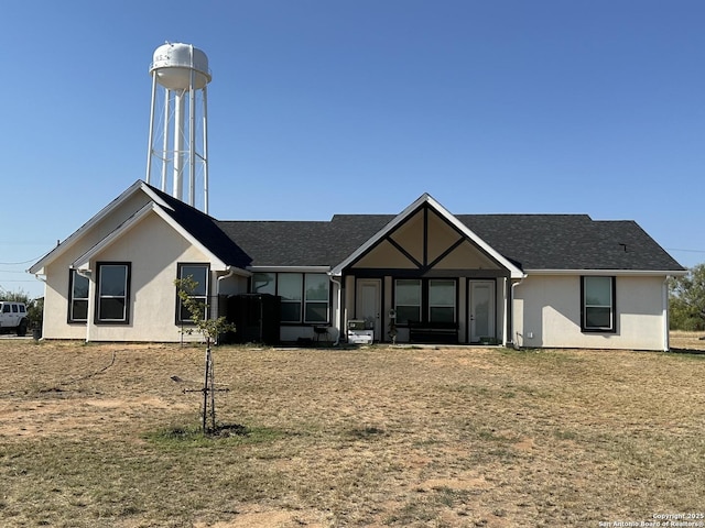 back of property featuring a yard