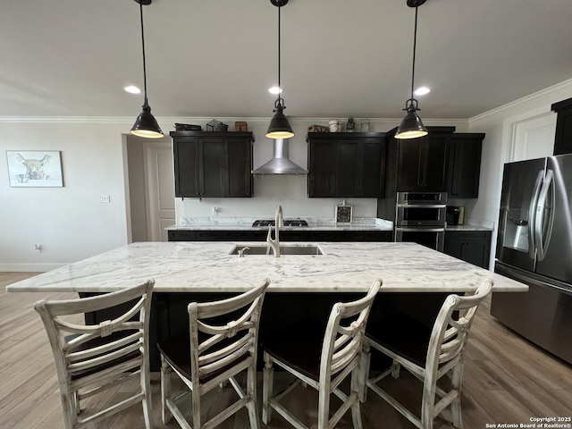 kitchen featuring sink, hanging light fixtures, a spacious island, and appliances with stainless steel finishes