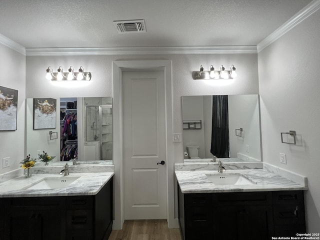 bathroom featuring crown molding, wood-type flooring, vanity, and toilet