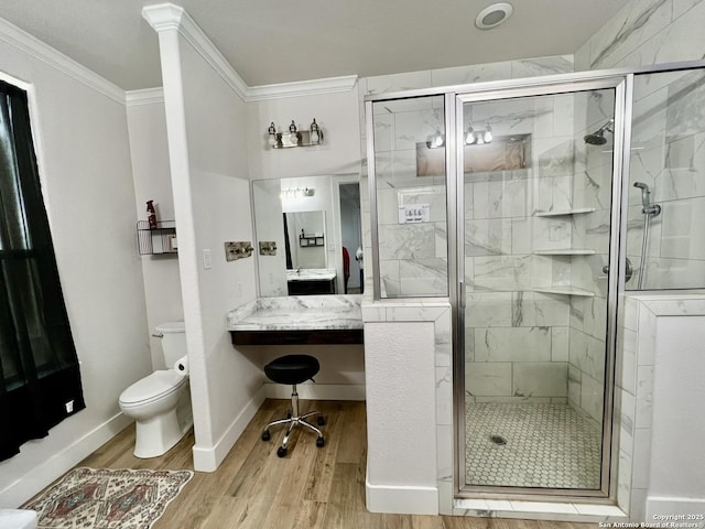 bathroom featuring crown molding, hardwood / wood-style flooring, vanity, toilet, and walk in shower