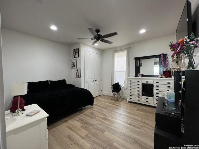 bedroom with a closet, ceiling fan, and light hardwood / wood-style flooring