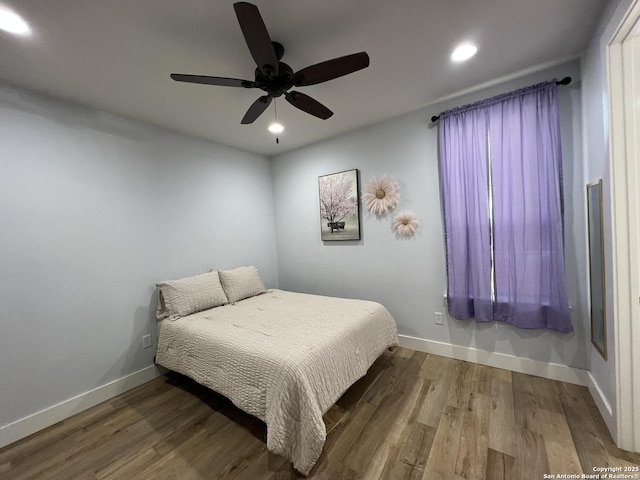 bedroom with ceiling fan and wood-type flooring