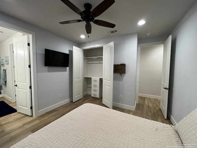 bedroom with hardwood / wood-style flooring, a closet, and ceiling fan