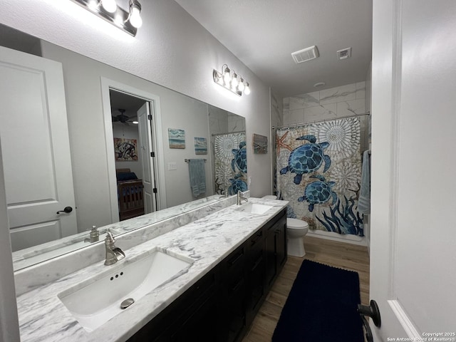 bathroom featuring toilet, hardwood / wood-style floors, vanity, and a shower with curtain