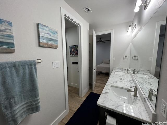 bathroom with vanity, hardwood / wood-style flooring, and ceiling fan