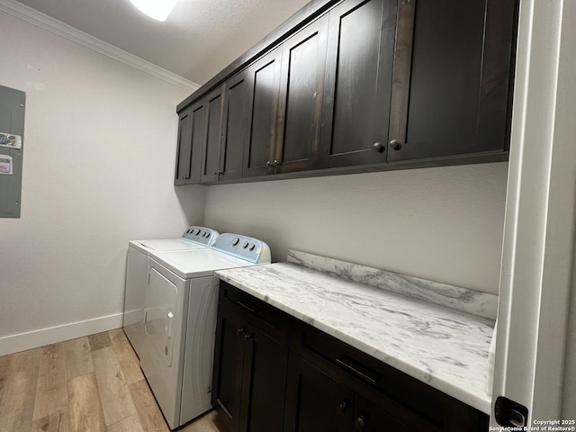 washroom with cabinets, crown molding, washer and dryer, and light hardwood / wood-style flooring