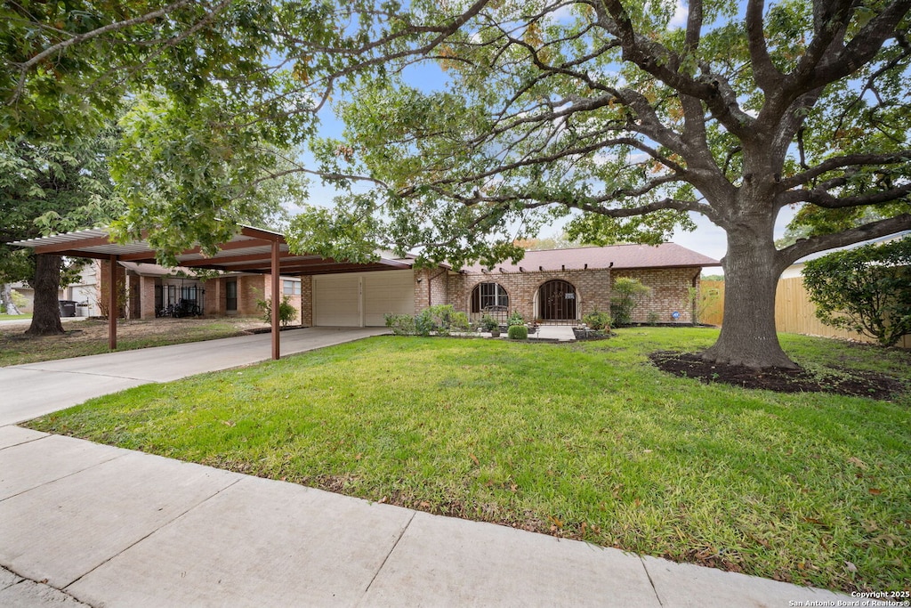 single story home featuring a front lawn and a carport