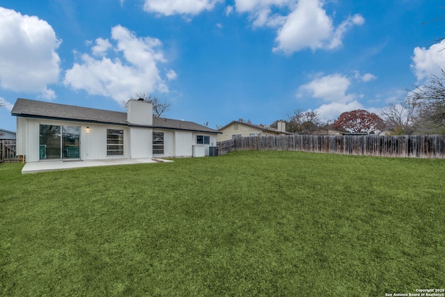 view of yard with central AC and a patio