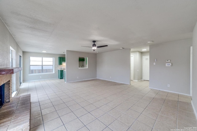 unfurnished living room featuring light tile patterned floors, a fireplace, and ceiling fan